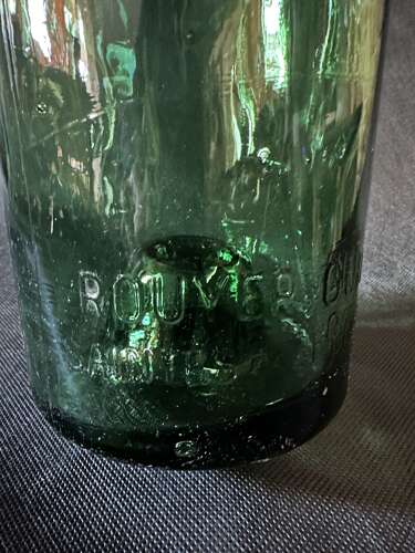 A WALL OF LARGE GREEN COGNAC BOTTLES, FRANCE C1935